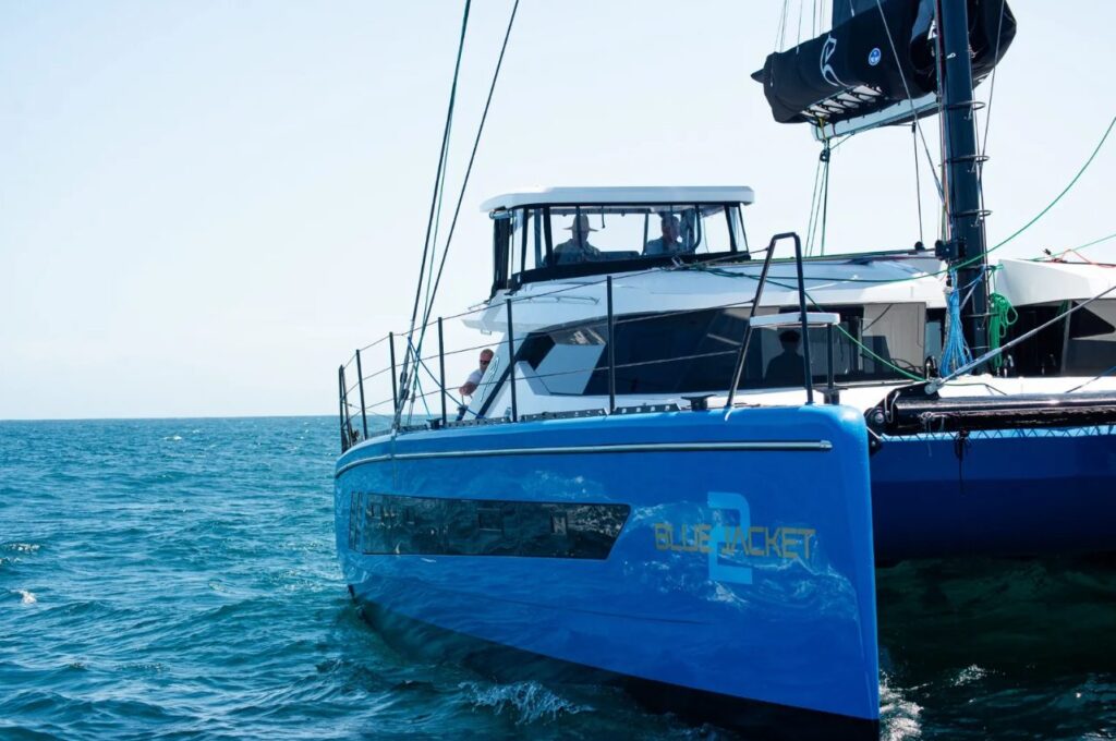 Blue Jacket II at anchor, bow and blue hull against the sea