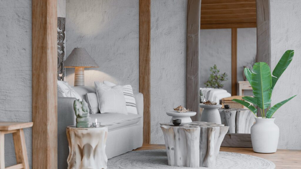 Bedroom corner at Serenity Villa with carved timber side tables and a potted palm